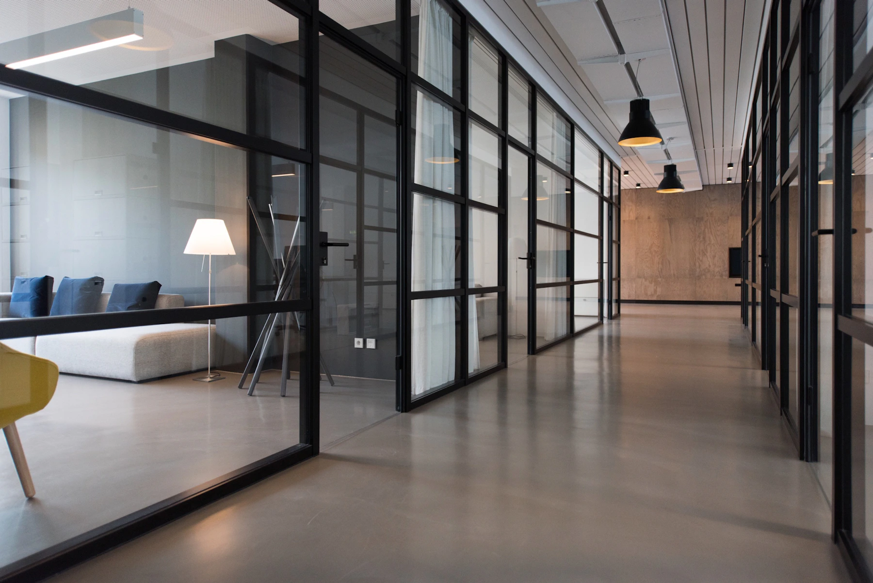 Illustrative sunlit open-plan office with timber furniture